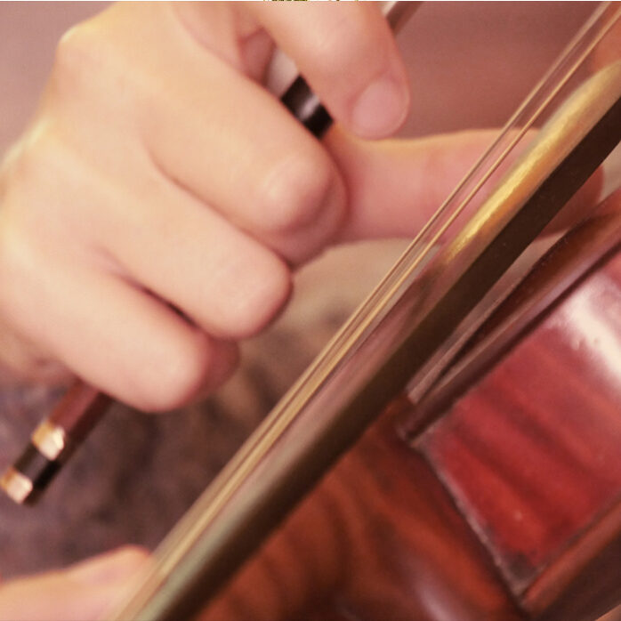 Close up of violin playing soundtracks by Sarah Llewellyn