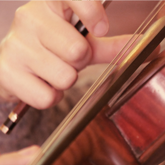 Close up of violin playing soundtracks by Sarah Llewellyn