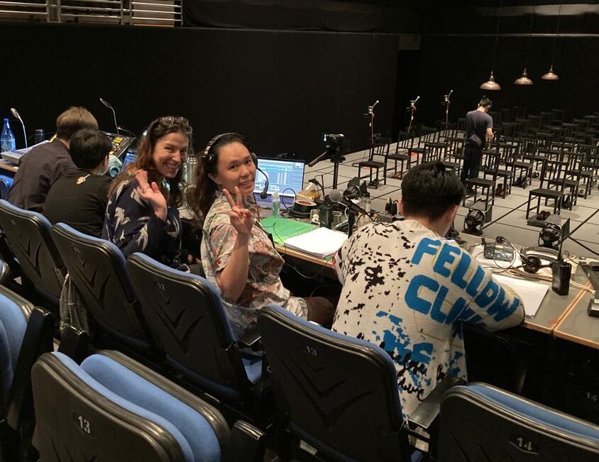 Composer Sarah Llewellyn at Sound Desk with tech crew at Chung Ying Theatre.
