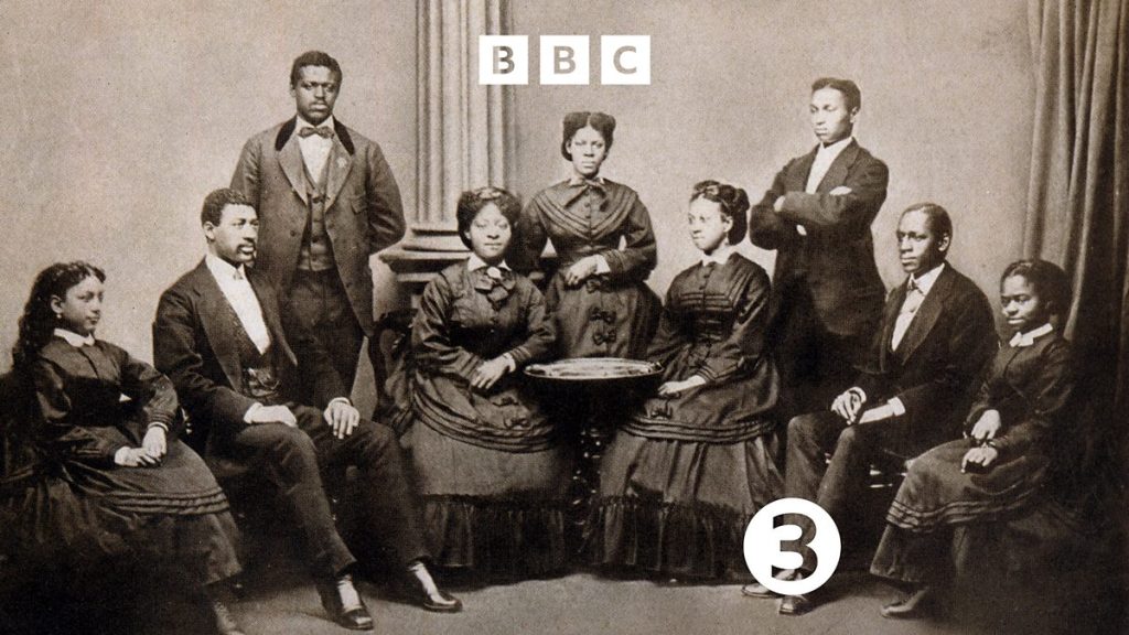 Radio 3 Drama Jubilee! production image. Nine black men and women in victorian costume depicting a choir.