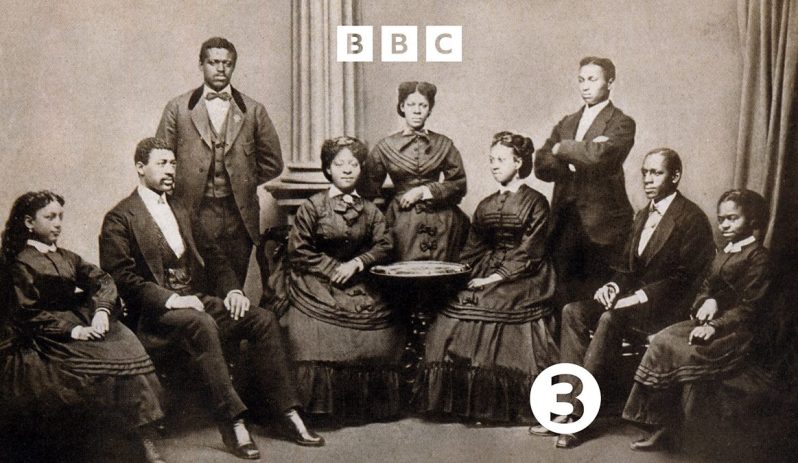 Radio 3 Drama Jubilee! production image. Nine black men and women in victorian costume depicting a choir.